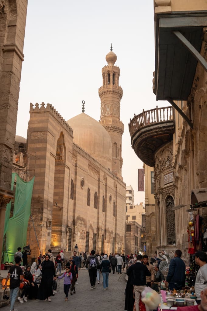 A bustling street under a mosque in Cairo, Egypt